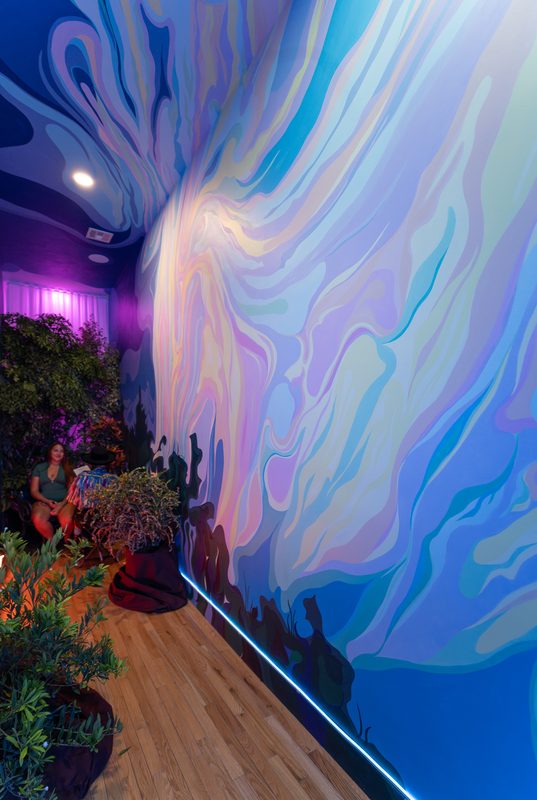 Installation view of the In Miami environment — mural, custom chairs, LED lighting, native plants